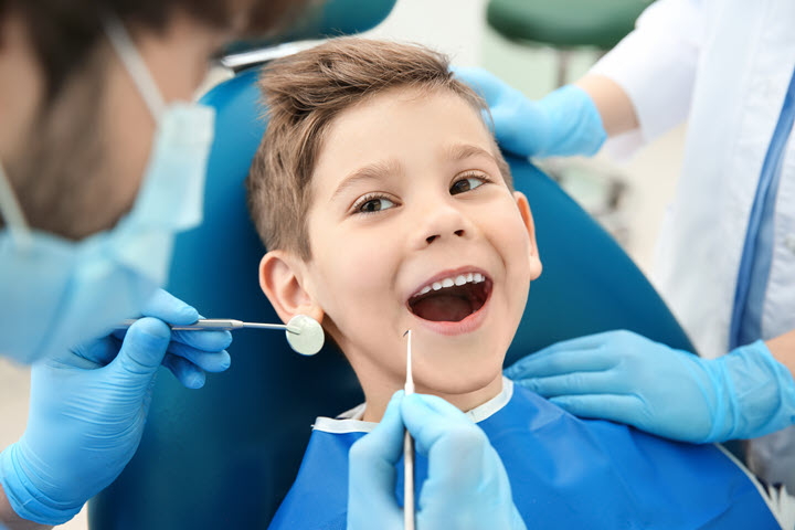 Dentist working on a young boys teeth