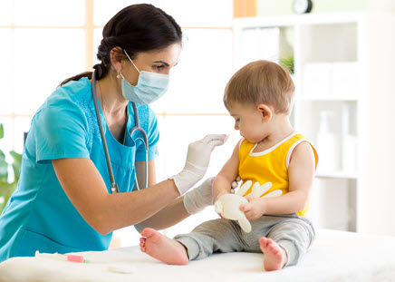 A female healthcare worker giving a young boy a vaccination